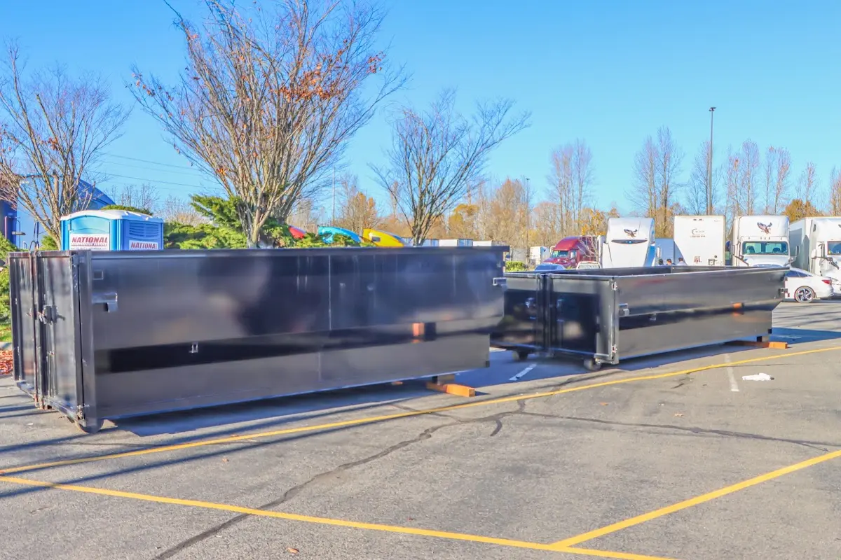 Professional dumpster rental service with roll-off container on residential driveway in Druid Hills